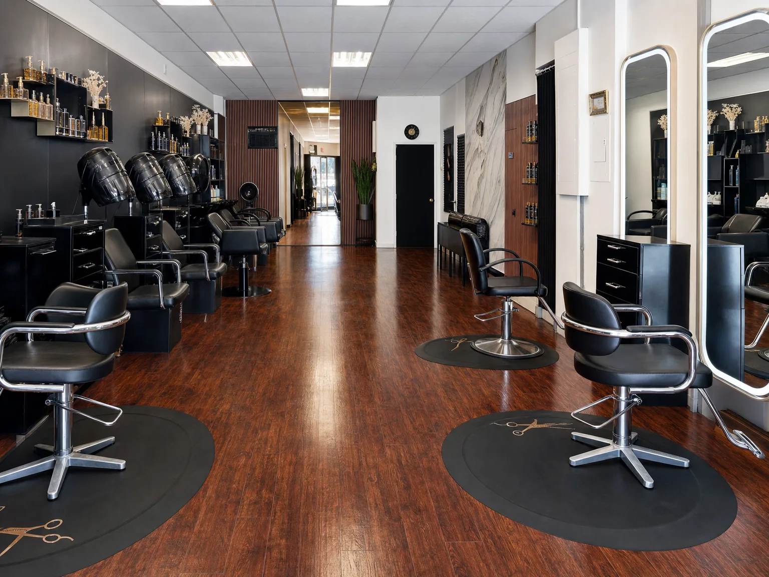 The styling floor — black chairs, gold mirrors, glossy wood